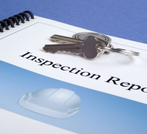 Inspection report or house check report, photographed with a set of house keys on top. Our own ohoto on brochure, no copyright issues.